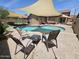 A covered pool in the backyard offers shade, lounge seating, and artificial turf at 9983 W Monterosa Ave, Phoenix, AZ 85037