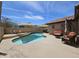 Sparkling pool in the backyard features comfortable patio seating and shade sails at 9983 W Monterosa Ave, Phoenix, AZ 85037