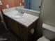 Close-up of a bathroom vanity with a white sink, gold-flecked counter, and wood cabinets at 1019 E Granada Ave, Apache Junction, AZ 85119