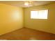 Bedroom with ceiling fan and natural light from the window featuring concrete floor at 1019 E Granada Ave, Apache Junction, AZ 85119