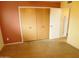 Bedroom featuring a closet and adjoining room with built-in shelves, plus concrete floors at 1019 E Granada Ave, Apache Junction, AZ 85119