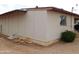 Exterior view of the home showcasing its siding, a window and shrubbery at 1019 E Granada Ave, Apache Junction, AZ 85119