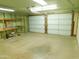 Spacious garage with two white garage doors and some shelving for storage at 1019 E Granada Ave, Apache Junction, AZ 85119