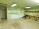 View of a cluttered garage interior featuring a door to the backyard and shelving at 1019 E Granada Ave, Apache Junction, AZ 85119