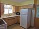 This is the kitchen featuring wooden cabinets, light countertops, and linoleum floors at 1019 E Granada Ave, Apache Junction, AZ 85119