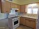 This is the kitchen with wooden cabinets, light countertops, and linoleum floors at 1019 E Granada Ave, Apache Junction, AZ 85119