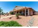 Spacious backyard featuring a covered patio, stone steps, and drought-resistant landscaping at 11023 W Chino Dr, Peoria, AZ 85373