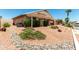 Low maintenance backyard showcasing stone landscaping, shaded patio, and privacy features at 11023 W Chino Dr, Peoria, AZ 85373