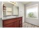 Bathroom featuring a granite countertop with a vanity and a window letting in natural light at 11023 W Chino Dr, Peoria, AZ 85373