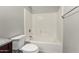 Bathroom with a white tiled shower and tub, next to the toilet at 11023 W Chino Dr, Peoria, AZ 85373