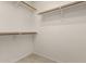 Spacious walk-in closet features wooden clothing racks and white shelving for optimal storage solutions at 11023 W Chino Dr, Peoria, AZ 85373