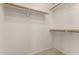 Spacious walk-in closet features wooden clothing racks and white shelving for optimal storage solutions at 11023 W Chino Dr, Peoria, AZ 85373