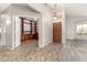 Open entryway featuring tile flooring and an office with built-in bookshelves at 11023 W Chino Dr, Peoria, AZ 85373