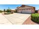 Charming single-story home featuring a spacious driveway, desert landscaping, and a two-car garage at 11023 W Chino Dr, Peoria, AZ 85373