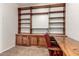 Home office showcasing wood built-in shelving, cabinets, and desk with a red chair at 11023 W Chino Dr, Peoria, AZ 85373
