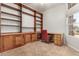 Home office featuring custom wood built-in shelving, cabinets, and a desk with drawers at 11023 W Chino Dr, Peoria, AZ 85373