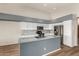 Modern kitchen boasts granite countertops, white cabinets, and stainless steel appliances at 11023 W Chino Dr, Peoria, AZ 85373