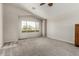 Bright living room with large window and neutral carpet, creating a cozy atmosphere at 11023 W Chino Dr, Peoria, AZ 85373