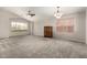 Spacious living room with vaulted ceilings, neutral carpet, and multiple windows at 11023 W Chino Dr, Peoria, AZ 85373