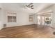 Open living room with hardwood floors, large windows, and sliding glass doors at 11023 W Chino Dr, Peoria, AZ 85373