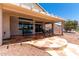 Inviting covered patio area featuring patterned tile flooring, seating, and low-maintenance landscaping at 11023 W Chino Dr, Peoria, AZ 85373
