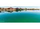 Expansive waterfront showcasing a community of homes along tranquil waters, reflecting clear skies at 11023 W Chino Dr, Peoria, AZ 85373