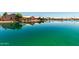 Picturesque waterfront view showcasing tranquil waters and a row of well-maintained homes at 11023 W Chino Dr, Peoria, AZ 85373