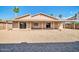 Wide backyard with a covered patio, complemented by gravel landscaping at 11044 N 75Th Dr, Peoria, AZ 85345