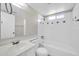 Well-lit bathroom featuring a shower-tub combo with decorative tiles and a vanity with sink at 11044 N 75Th Dr, Peoria, AZ 85345