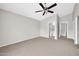 Large bedroom featuring carpet floors, neutral walls, and an attached bathroom at 11044 N 75Th Dr, Peoria, AZ 85345