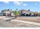 Charming single-story home featuring a two-car garage and a well-maintained, low-maintenance yard with a young palm tree at 11044 N 75Th Dr, Peoria, AZ 85345