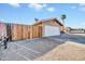View of side facing garage with wooden fence along drive and a palm tree visible in the back yard at 11044 N 75Th Dr, Peoria, AZ 85345