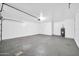 Spacious two-car garage with concrete flooring, ample space for parking and storage, with a water heater at 11044 N 75Th Dr, Peoria, AZ 85345