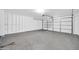 Spacious two-car garage with concrete flooring, offering ample parking and storage space at 11044 N 75Th Dr, Peoria, AZ 85345