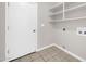 Bright laundry room with ample shelving, providing convenient storage and functionality at 11044 N 75Th Dr, Peoria, AZ 85345