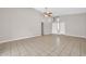 Spacious living room featuring neutral paint, tile floors, ceiling fan and plentiful natural light from clerestory windows at 11044 N 75Th Dr, Peoria, AZ 85345