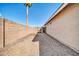 Gravel side yard with block and wood fencing, offering a secure and low-maintenance outdoor space at 11044 N 75Th Dr, Peoria, AZ 85345