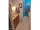 Modern bathroom with a stylish vanity, framed art, and a glass-enclosed shower, offering a spa-like experience at 1160 W Ivanhoe St, Chandler, AZ 85224