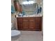 Well-appointed bathroom with wood vanity, featuring ample storage and a full mirror, adding a touch of elegance at 1160 W Ivanhoe St, Chandler, AZ 85224