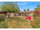 Well-maintained backyard showcasing green lawns, patio area, BBQ and beautiful flowers at 1179 E Cordova Ave, Casa Grande, AZ 85122