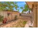 Backyard shed has tools for gardening, surrounded by a tidy brick border and sunny lawn at 1179 E Cordova Ave, Casa Grande, AZ 85122