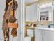 Cozy bathroom featuring white cabinets, a toilet, sink, and a mirrored medicine cabinet at 1179 E Cordova Ave, Casa Grande, AZ 85122