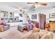 Spacious bedroom with white built-in bookshelves, a reading chair, and ceiling fans at 1179 E Cordova Ave, Casa Grande, AZ 85122