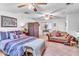 Cozy bedroom offering ample space with couch, ceiling fans, and a charming decorative privacy screen at 1179 E Cordova Ave, Casa Grande, AZ 85122
