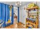 Dining area showcasing wooden wine rack, fan, and blue curtains to next room at 1179 E Cordova Ave, Casa Grande, AZ 85122