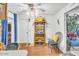 Bright dining area with wooden wine rack, fan, and blue curtains at 1179 E Cordova Ave, Casa Grande, AZ 85122