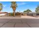 Charming single-story home featuring mature palm trees and a spacious driveway at 1179 E Cordova Ave, Casa Grande, AZ 85122