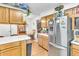 Bright kitchen with stainless steel refrigerator, oak cabinets, and a wine rack at 1179 E Cordova Ave, Casa Grande, AZ 85122