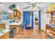 Eat-in kitchen with hardwood floors, breakfast bar, and decorative blue curtains at 1179 E Cordova Ave, Casa Grande, AZ 85122
