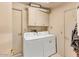 Convenient laundry area with appliances, storage cabinets, and access doors at 1179 E Cordova Ave, Casa Grande, AZ 85122